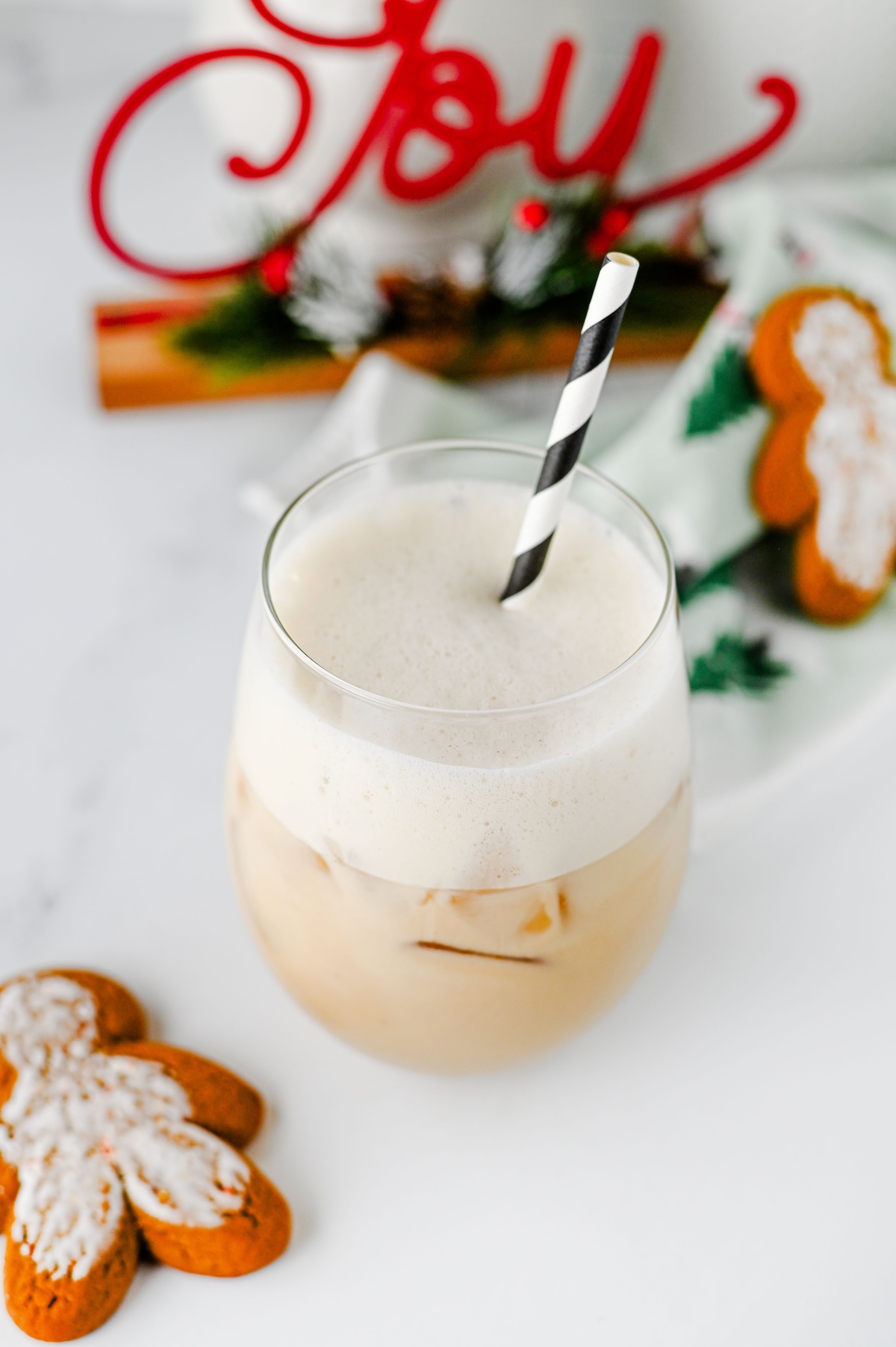 Close-up of the frothy oat milk foam on top of an iced gingerbread chai latte