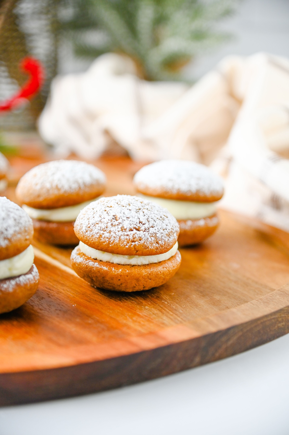 Close-up of a gingerbread whoopie pie with cream cheese filling and a light dusting of powdered sugar