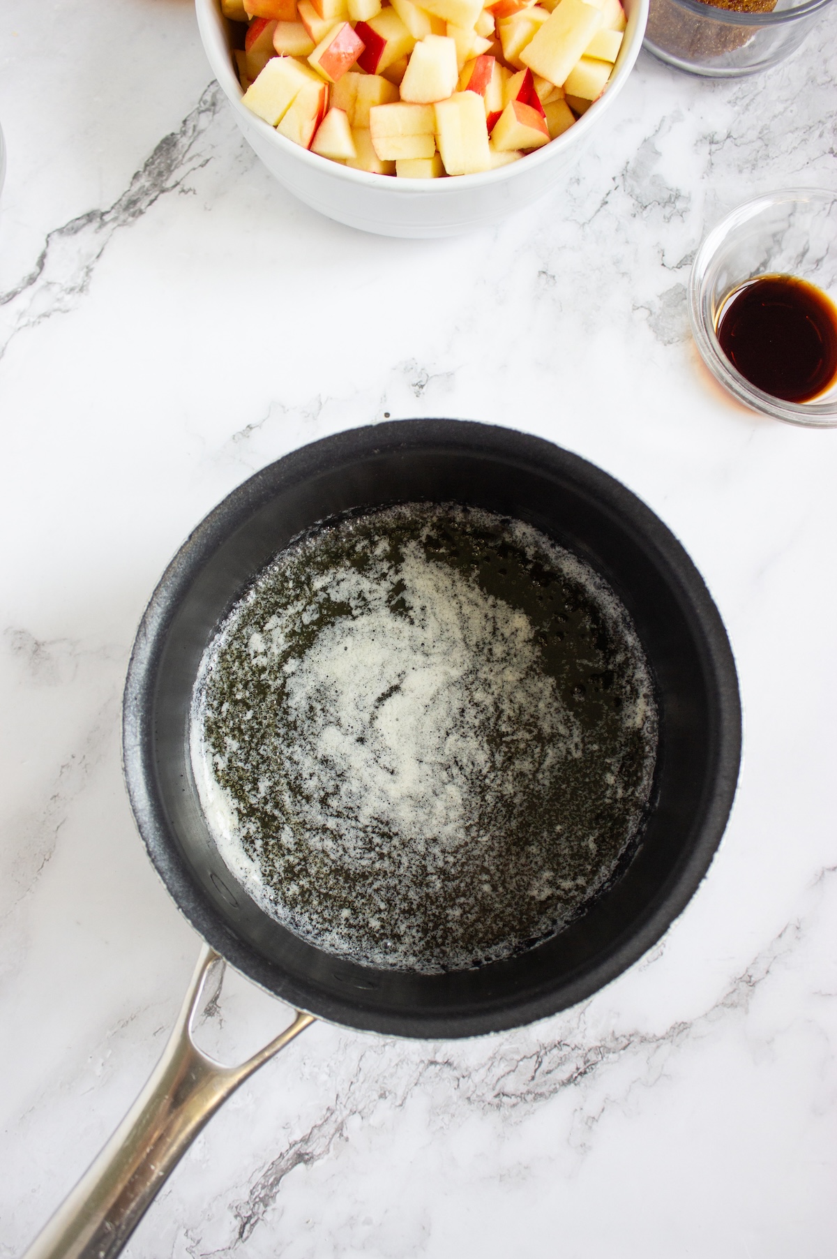 Butter melting in a saucepan to start the caramel apple compote