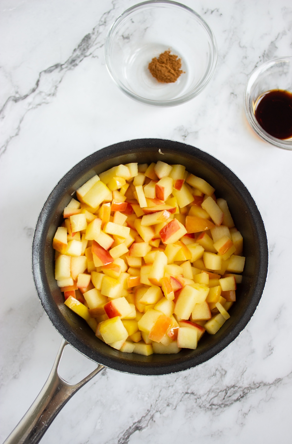 Diced apples sautéing in melted butter in a saucepan