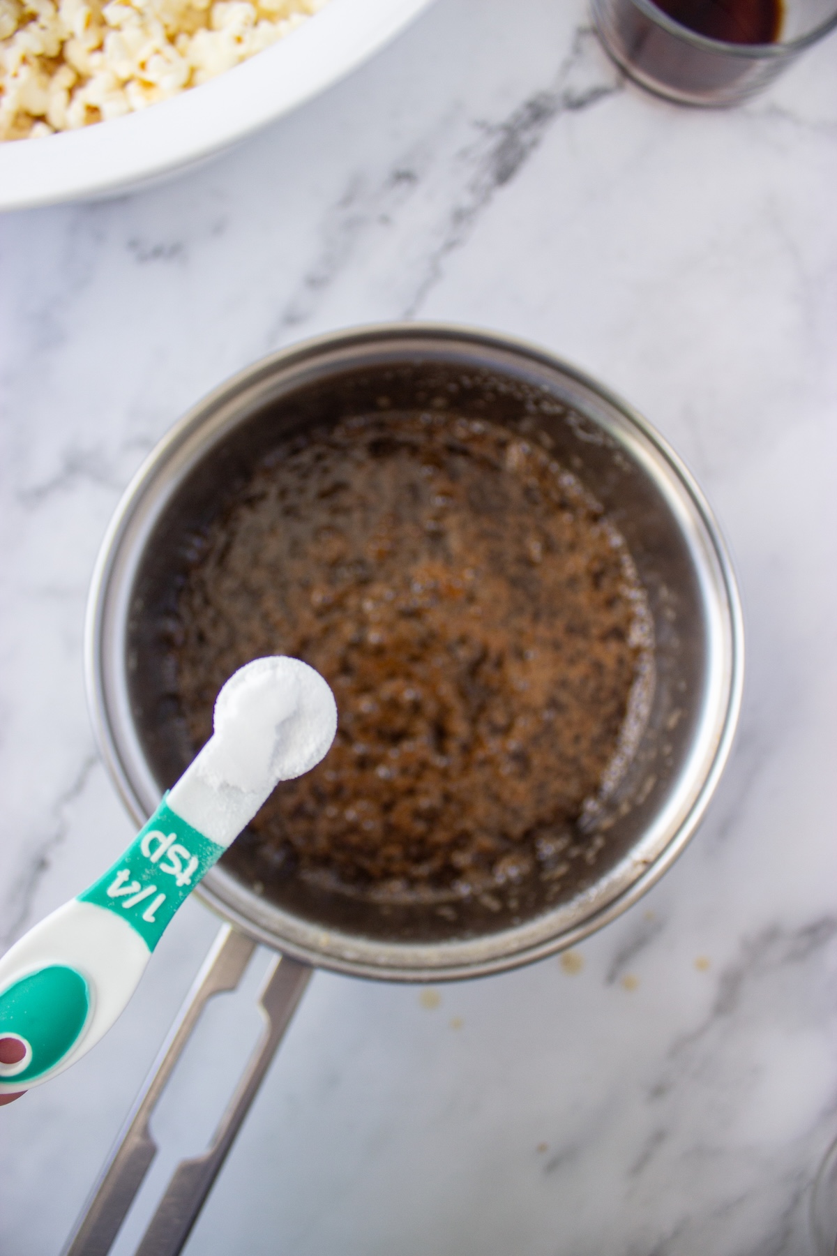Baking soda stirred into the brown butter maple caramel in a saucepan