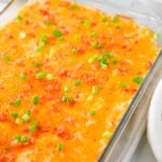 Cheesy crack chicken dip with bacon and green onions, ready to serve