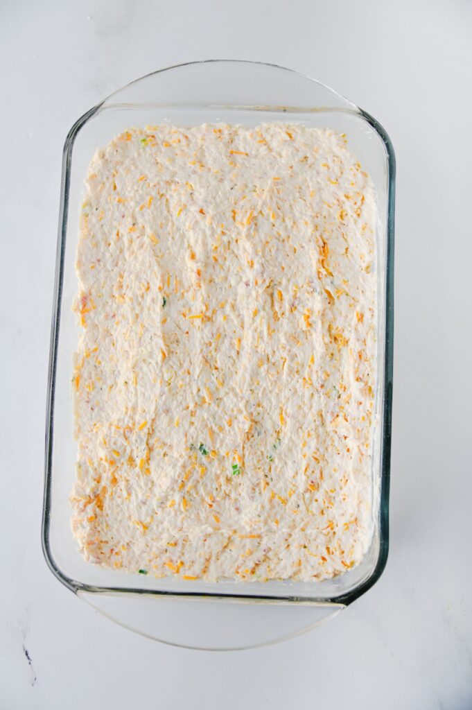 Crack chicken dip mixture spread evenly in a glass baking dish before baking